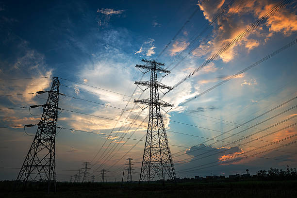 Electricity Pylon power line transmission tower at sunset